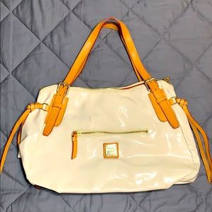 Dooney & Burke cream colored patent leather purse.